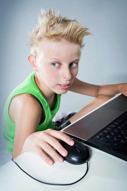 Teenager sitting behind a computer