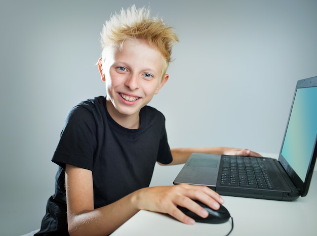 Teenager sitting behind a computer