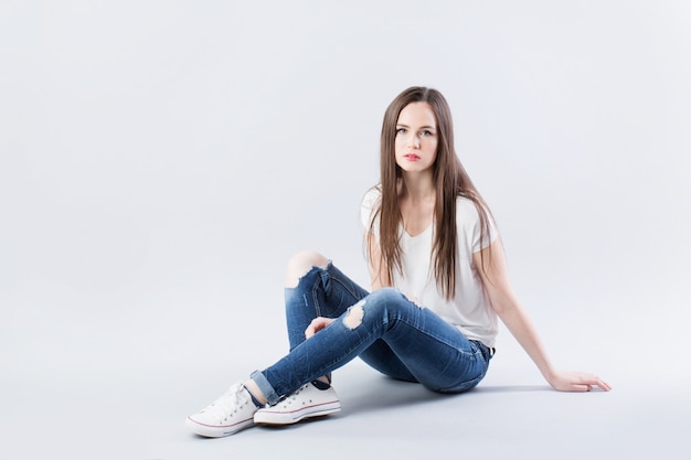 Teenager sitting on the floor