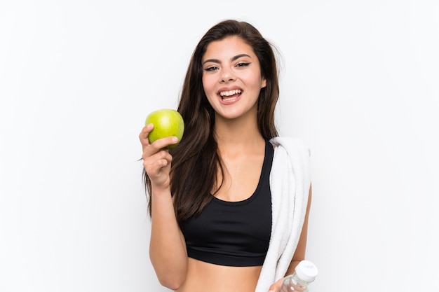 Teenager sport girl over isolated white background with an apple