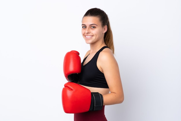 Teenager sport girl over isolated white with boxing gloves