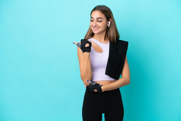 Teenager student girl isolated on blue background shouting with mouth wide open to the side