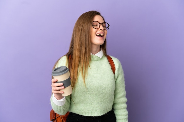 Teenager student girl over isolated purple background laughing in lateral position