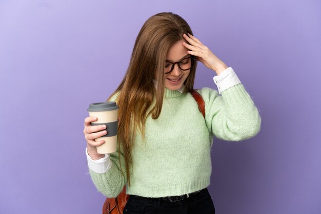 Teenager student girl over isolated purple background laughing