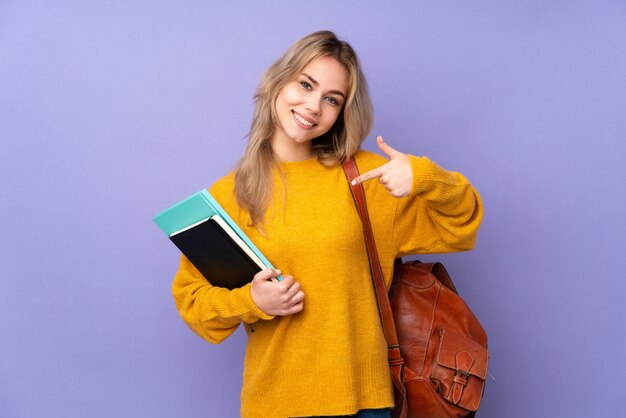 Teenager student girl on purple proud and self-satisfied