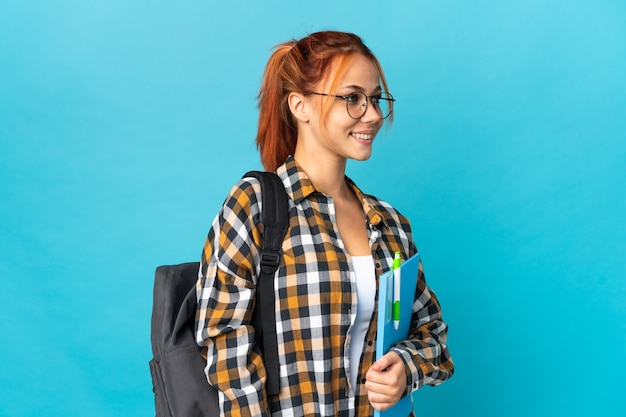 Teenager student Russian girl on blue looking side