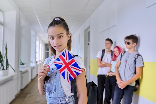 Teenager student with British flag school corridor group of students background UK Kingdom England school education youth people concept