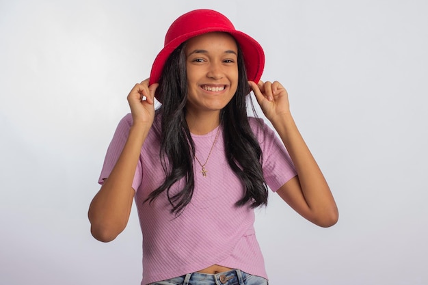 Teenager in studio photo with facial expressions and with red hat