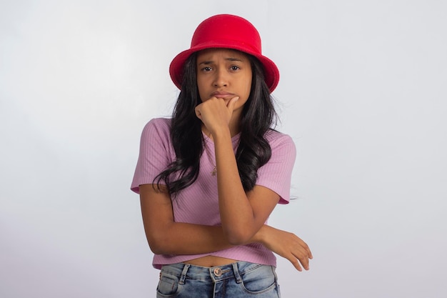 Teenager in studio photo with facial expressions and with red hat