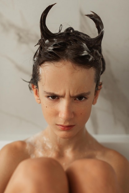 Teenager takes a bubble bath