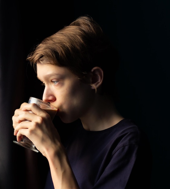 teenager at the window, pensive