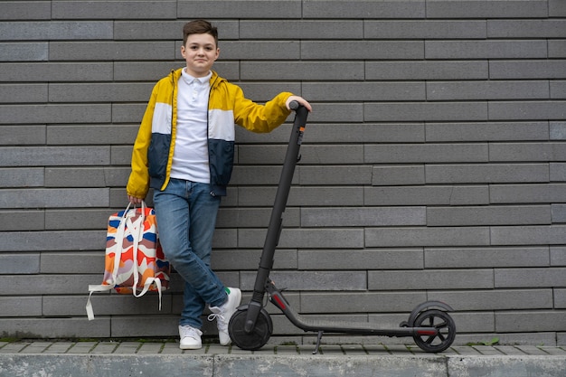 Teenager with backpack and electric scooter