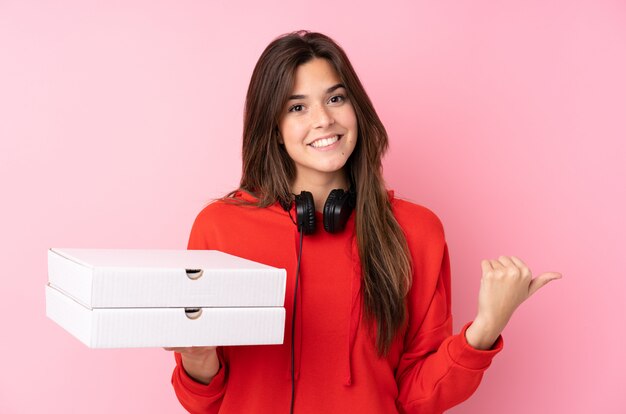 Teenager woman holding pizzas