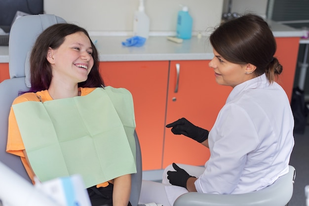 Teenager woman treating teeth at dentist office, consultation of orthodontist  