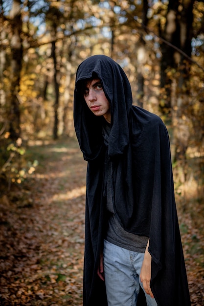 Teenagers in Halloween costumes in the woods. Halloween vampire in the woods