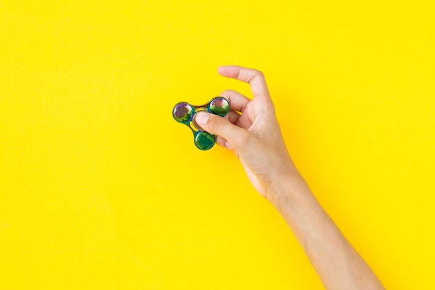 a teenagers hand with a finger will launch a spinner