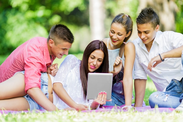 Teenagers in the park with tablet