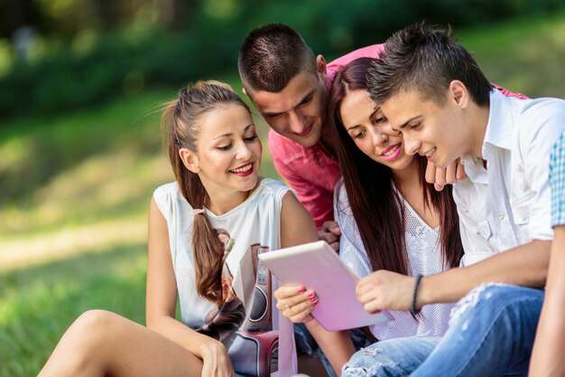 Teenagers in the park with tablet