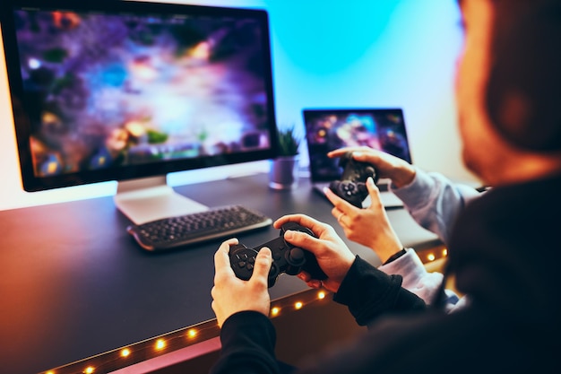 Teenagers playing video game gamers playing championship tournament competition and having fun