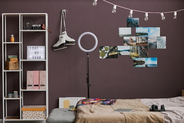 Teenagers room interior with hobbie items on maroon wall