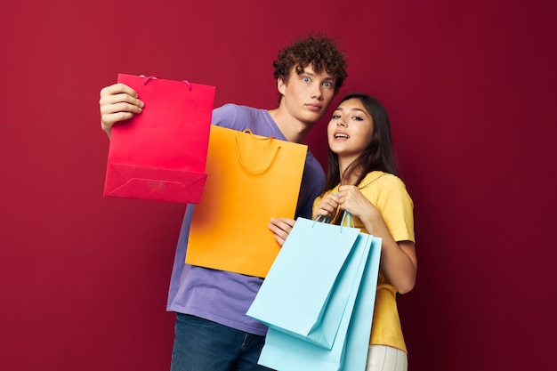 Teenagers shopping bags in hand isolated background unaltered