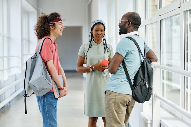 Teenagers talking during break at corridor