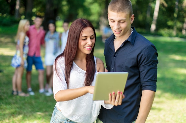 Teenagers with tablet in the park