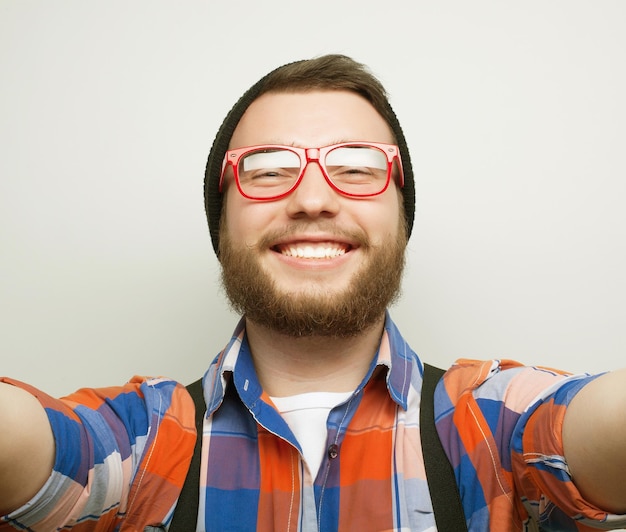 Tehnology concept Happy selfie Knappe jonge man die camera vasthoudt en selfie maakt en glimlacht