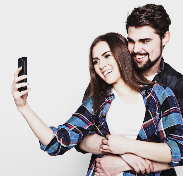 Photo tehnology, internet, emotional and people concept: capturing happy moments together. happy young loving couple making selfie and smiling.special fashionable toning.