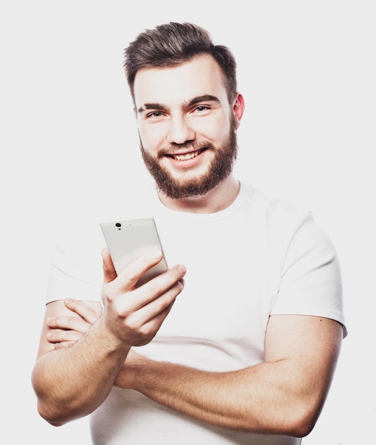 Tehnology and people concept Bearded man typing sms on white background