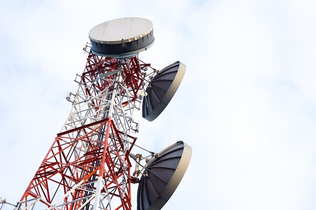 Telecommunication antenna tower on the white sky