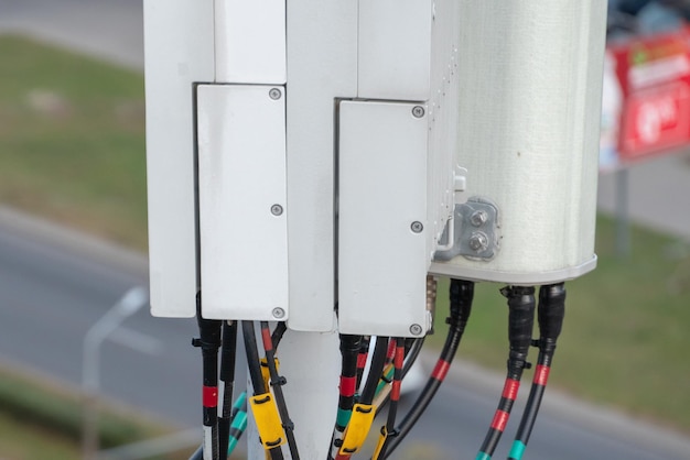 Telecommunication equipment cellular station on tower macro\
base station 5g radio network telecommunication equipment with\
radio modules and smart antennas dangerous radiation from 5g\
networks