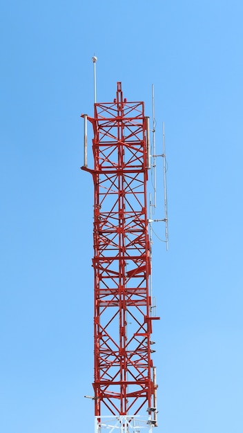 Telecommunication tower closeup with red and white color.