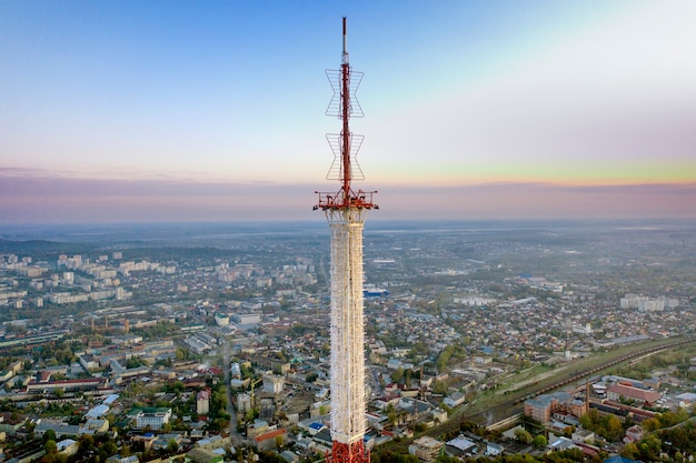 Telecommunication tower for mobile phone service and wireless 5g communication. Against the background of the city