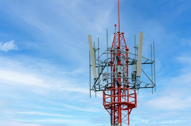 Telecommunication tower with blue sky and white clouds background antenna on blue sky