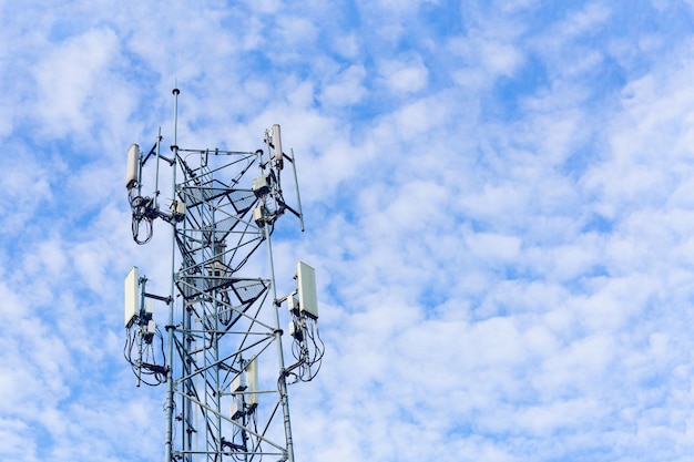 Telecommunication tower with blue sky and white