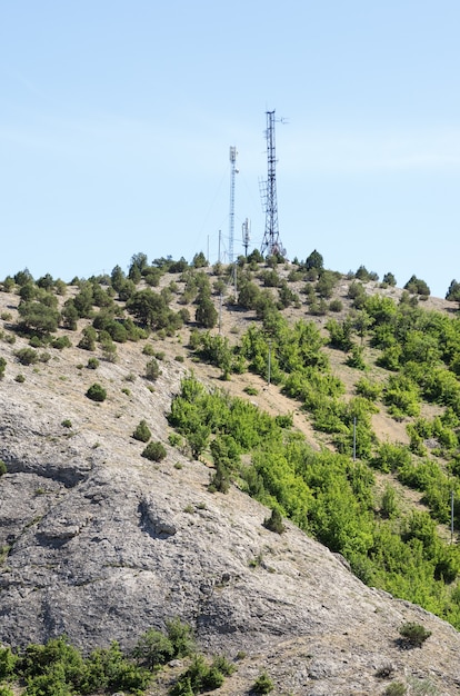 Telecommunication towers with antennas on top of the mountain. Russia, the Republic of Crimea