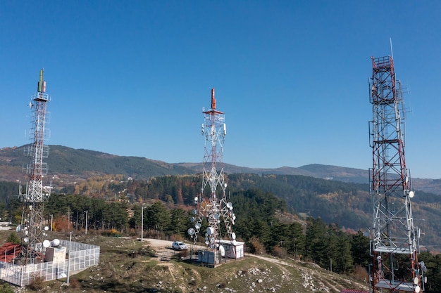 Telecommunications antenna tower in the morning. bright sunshine and blue sky with clouds. Transmitting antenna pairs. High quality photo