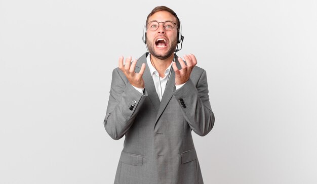 telemarketer businessman looking desperate, frustrated and stressed