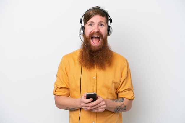 Telemarketer man isolated on white background surprised and sending a message