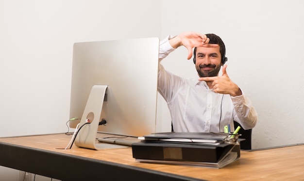 Telemarketer man in a office focusing face. Framing symbol