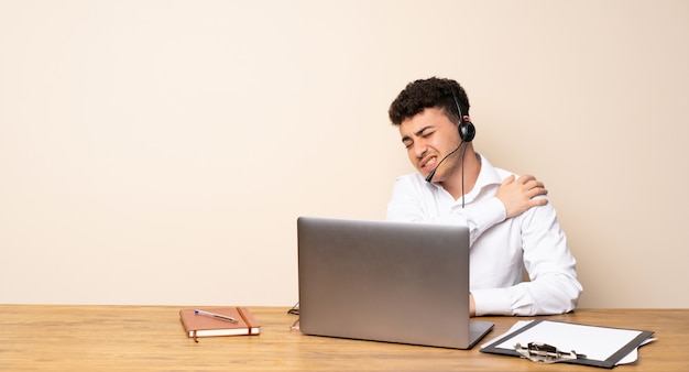 Telemarketer man suffering from pain in shoulder for having made an effort