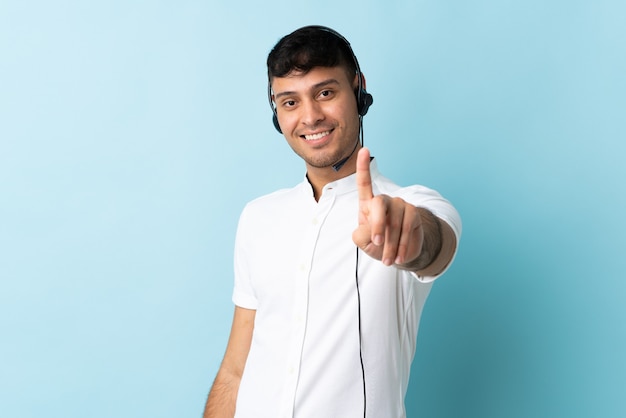 Telemarketer man working with a headset