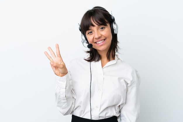 Telemarketer mixed race woman working with a headset isolated on white background happy and counting three with fingers