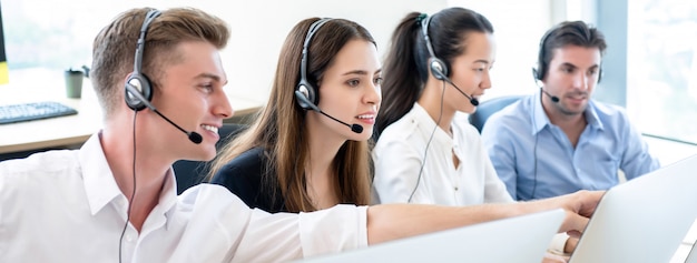 Telemarketing team working together in call center office