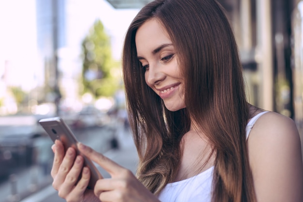 Telephone cellular user student lady business work model concept. Profile side close up view photo portrait of beautiful glad nice excited pretty teenager looking at picture she got from friend