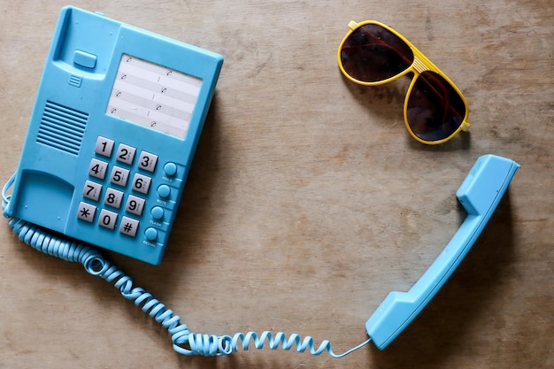 Telephone and sunglasses on table