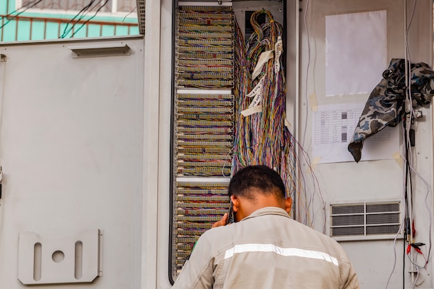 Telephone technician checks the coaxial cable