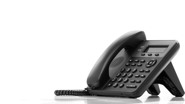 Telephone with VOIP isolated on white background customer service support call center concept Modern VoIP or IP phone Communication support call center and customer service help desk