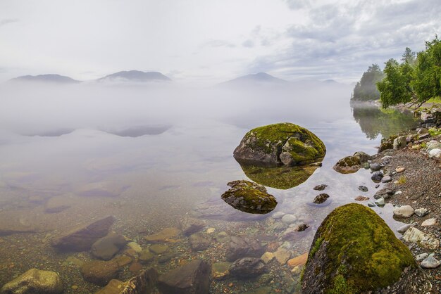 Teletskoye-meer in de mistige ochtend van het Altai-gebergte